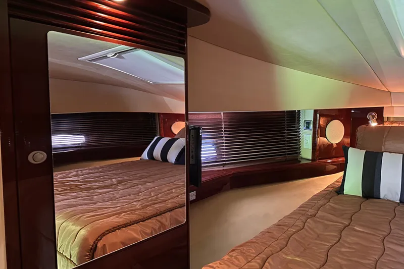 Slide: The Image of Luxurious interior of 2007 Sea Ray 48 Sundancer yacht with elegant bedding and wood finishes. - 32