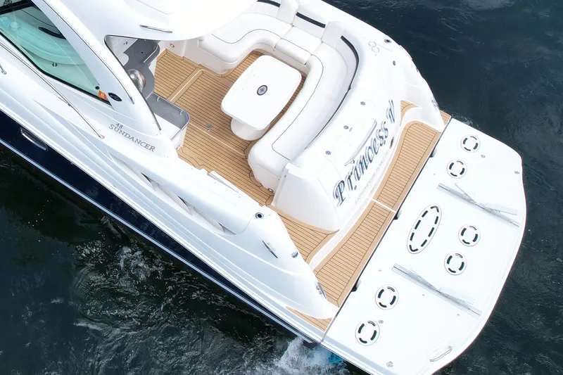 Slide: The Image of 2007 Sea Ray 48 Sundancer yacht with spacious deck and elegant seating on water. - 28