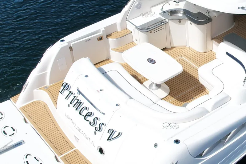 Slide: The Image of 2007 Sea Ray 48 Sundancer yacht with elegant deck and seating area on water. - 26
