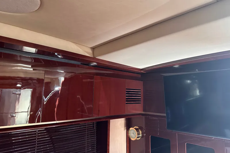Slide: The Image of Interior of 2007 Sea Ray 48 Sundancer yacht with glossy wood finish and mounted TV. - 59