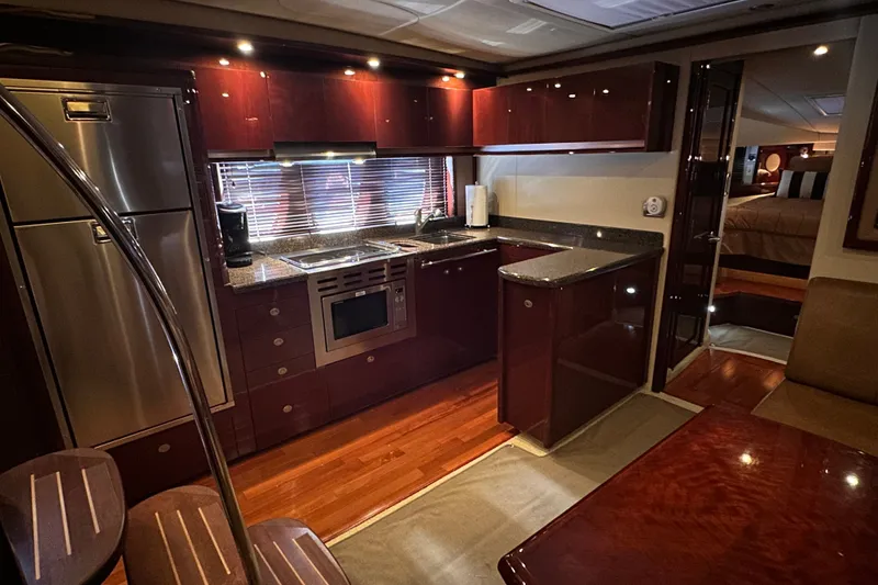 Slide: The Image of Luxurious 2007 Sea Ray 48 Sundancer yacht interior with modern kitchen and elegant wood finishes. - 43