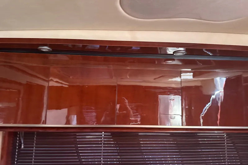 Slide: The Image of Interior of 2007 Sea Ray 48 Sundancer with glossy wood paneling and recessed lighting. - 58
