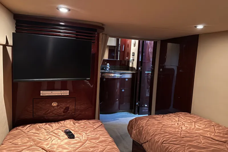 Slide: The Image of Luxurious cabin interior of 2007 Sea Ray 48 Sundancer yacht with TV and twin beds. - 48