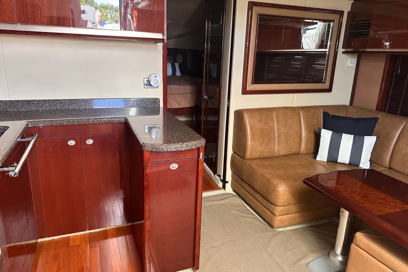 Slide: The Image of Luxurious interior of 2007 Sea Ray 48 Sundancer yacht with elegant wood finishes and cozy seating. - 54