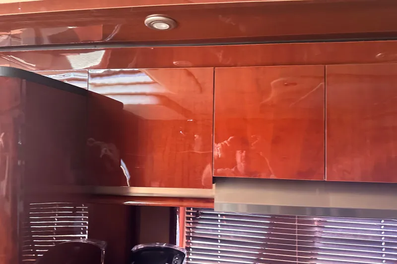 Slide: The Image of Interior of 2007 Sea Ray 48 Sundancer with glossy wooden cabinets and blinds. - 61