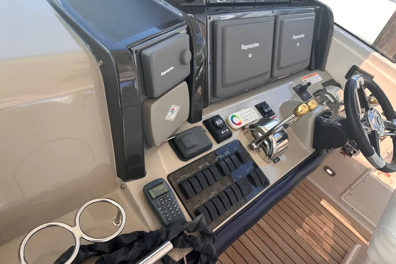Slide: The Image of Helm of 2007 Sea Ray 48 Sundancer with Raymarine electronics and dual throttle controls. - 9