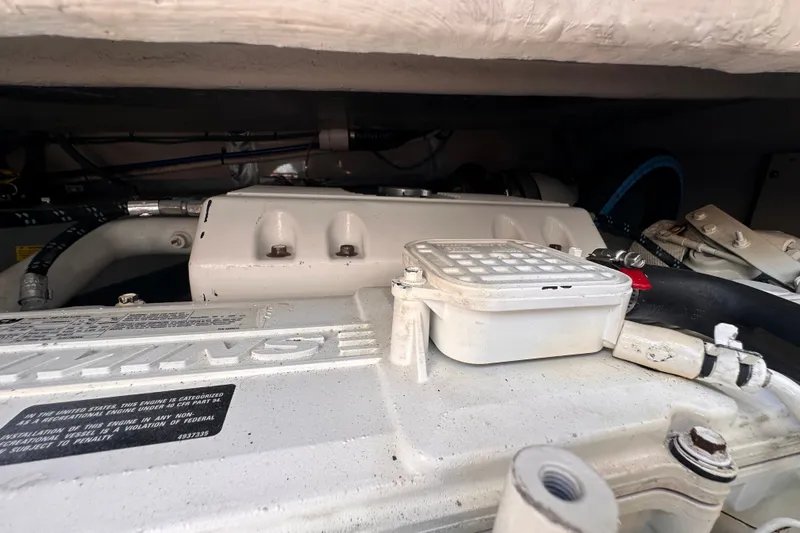 Slide: The Image of Engine compartment of a 2007 Sea Ray 48 Sundancer boat, showcasing mechanical components. - 82