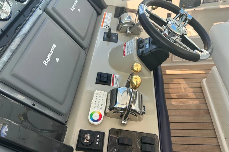 Slide: The Image of Helm of 2007 Sea Ray 48 Sundancer with Raymarine electronics and dual throttle controls. - 13