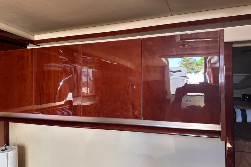 Slide: The Image of Interior of 2007 Sea Ray 48 Sundancer yacht with glossy wooden cabinetry. - 63