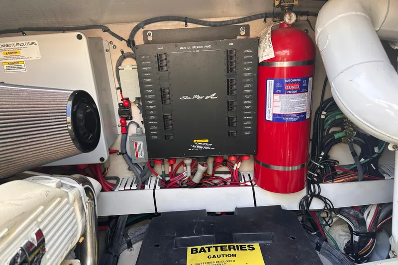 Slide: The Image of Engine room of 2007 Sea Ray 48 Sundancer with control panel and fire extinguisher. - 67
