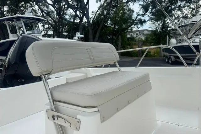 Slide: The Image of 2022 Boston Whaler 190 Montauk boat interior with cushioned seating and sleek design. - 14