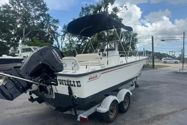 Slide: The Image of 2022 Boston Whaler 190 Montauk boat on trailer, featuring a Mercury outboard motor. - 2