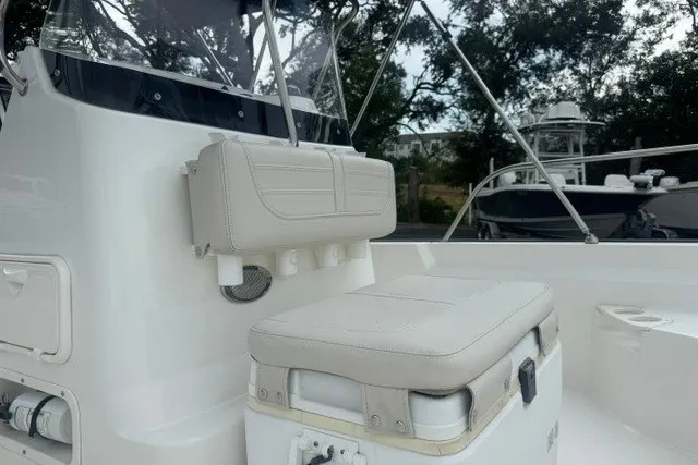 Slide: The Image of 2022 Boston Whaler 190 Montauk boat interior with cushioned seating and storage. - 17