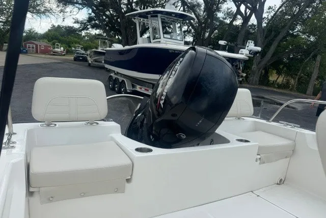 Slide: The Image of 2022 Boston Whaler 190 Montauk boat with outboard motor, parked on a trailer. - 19