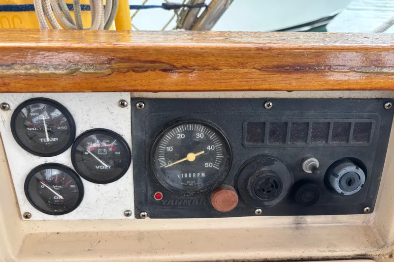 Slide: The Image of Control panel of a 1989 Island Packet 35 sailboat with gauges and switches. - 15