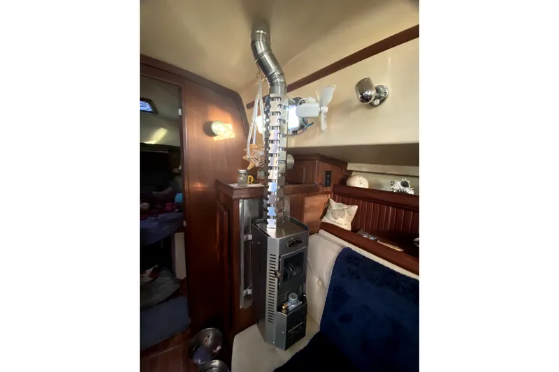 Slide: The Image of Interior of 1989 Island Packet 35 sailboat with heater and cozy seating area. - 10