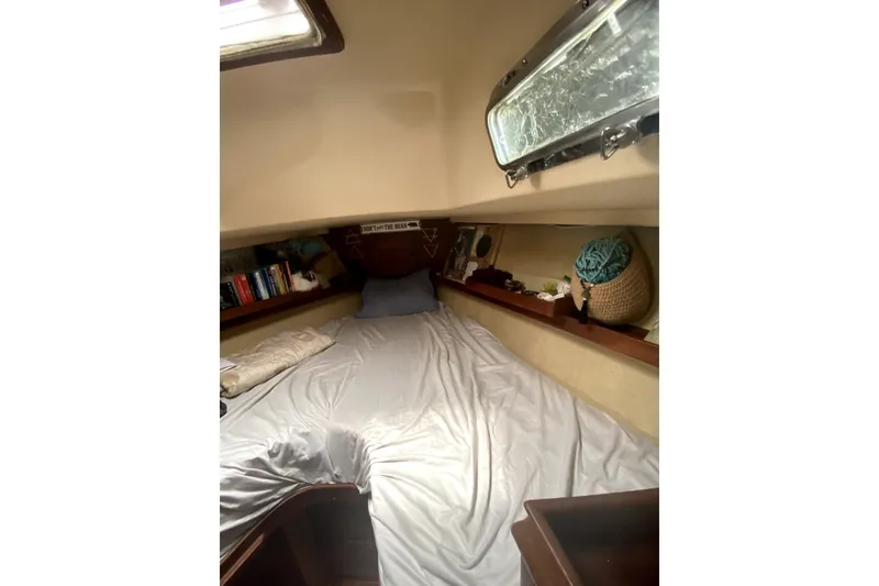 Slide: The Image of Cozy cabin interior of 1989 Island Packet 35 sailboat with bed and shelves. - 8