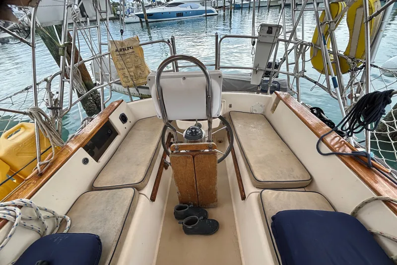Slide: The Image of Cockpit of 1989 Island Packet 35 sailboat with seating and steering wheel. - 14