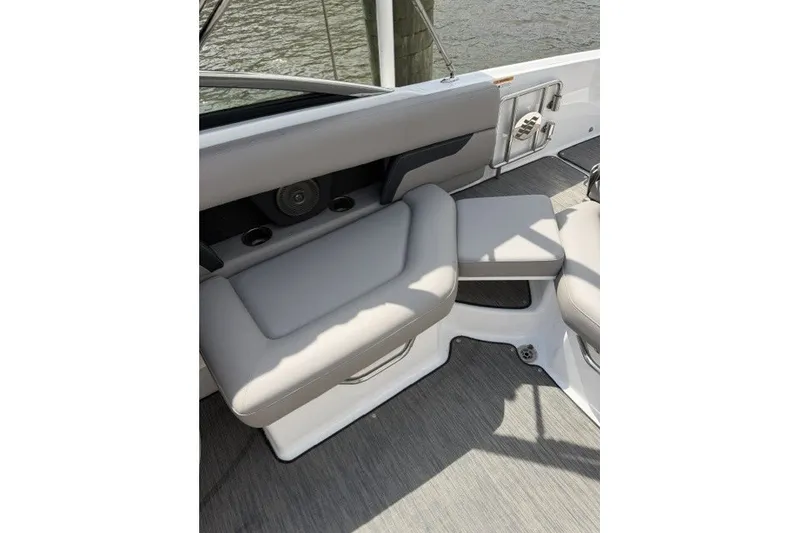 Slide: The Image of 2022 Four Winns HD5 OB boat interior with gray seating and cup holders. - 23