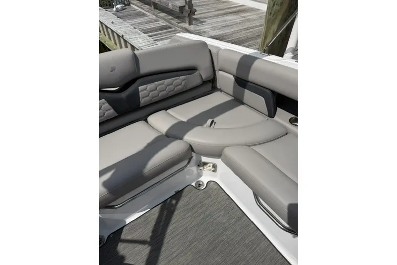 Slide: The Image of 2022 Four Winns HD5 OB boat interior with gray cushioned seating. - 21