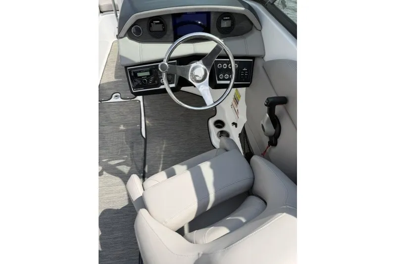 Slide: The Image of 2022 Four Winns HD5 OB boat cockpit with modern steering and controls. - 6