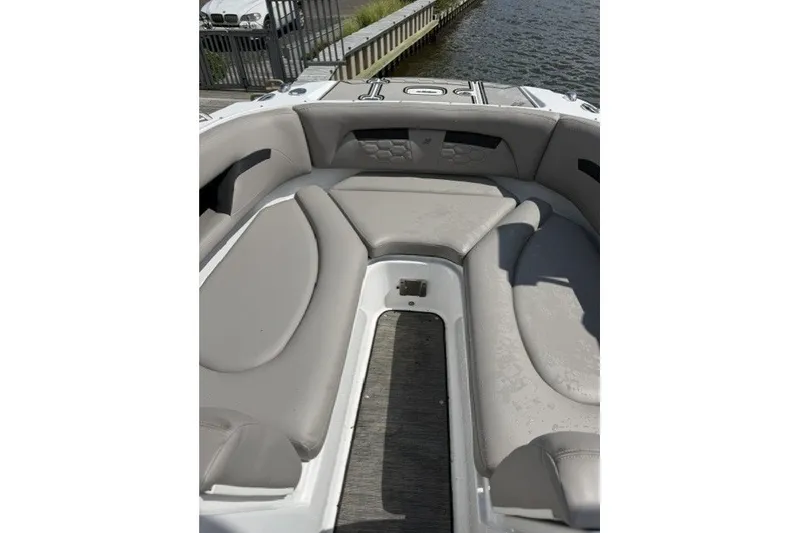 Slide: The Image of 2022 Four Winns HD5 OB boat interior with gray seating and water view. - 12