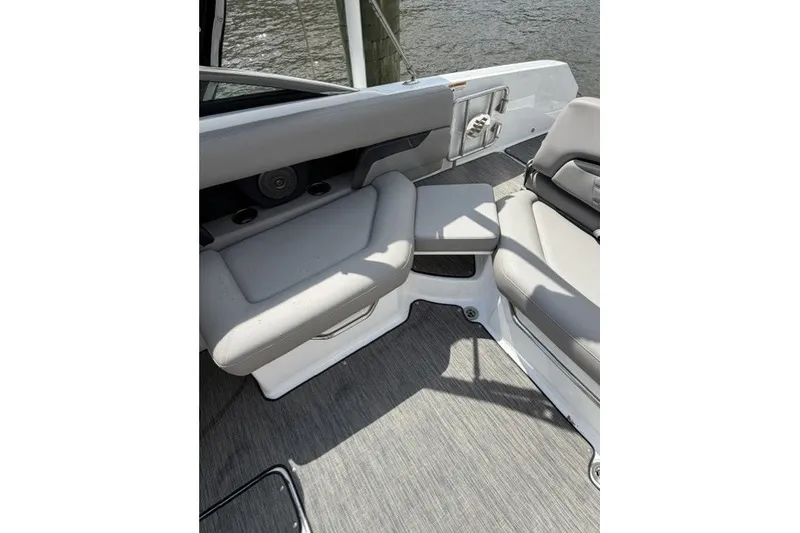 Slide: The Image of Interior seating of 2022 Four Winns HD5 OB boat, featuring gray upholstery and sleek design. - 24