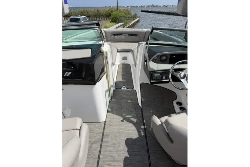 Slide: The Image of Interior view of 2022 Four Winns HD5 OB boat, featuring sleek seating and modern dashboard. - 13