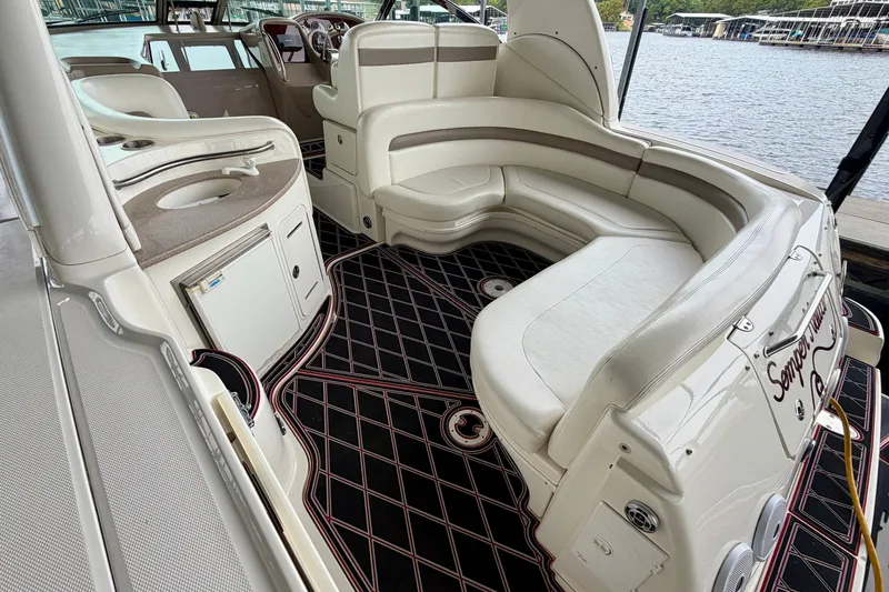 Slide: The Image of 2003 Sea Ray Sundancer 320 interior with plush seating and elegant design by the water. - 14