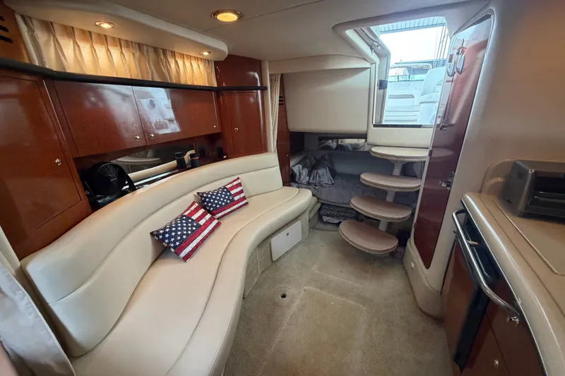 Slide: The Image of Luxurious interior of 2003 Sea Ray Sundancer 320 yacht with elegant seating and American flag pillows. - 31