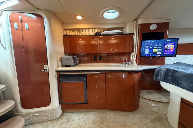 Slide: The Image of Interior of 2003 Sea Ray Sundancer 320 yacht with kitchenette and mounted TV. - 28