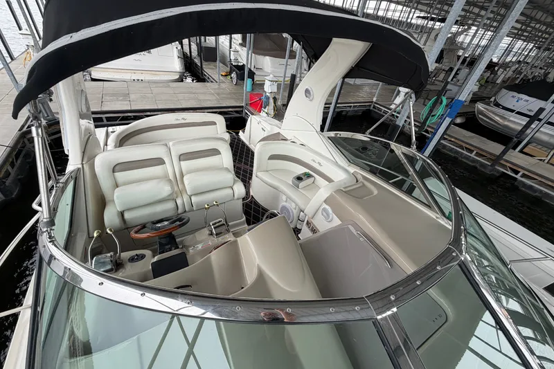 Slide: The Image of 2003 Sea Ray Sundancer 320 boat interior with helm and seating under canopy. - 25
