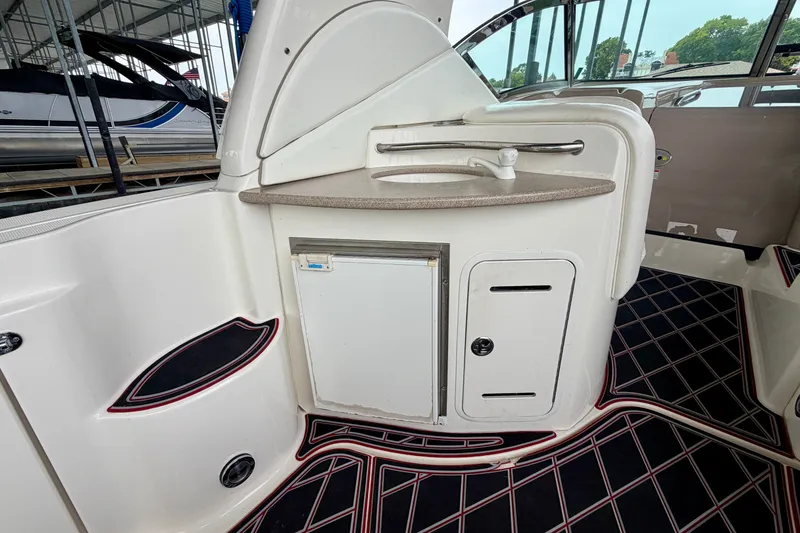 Slide: The Image of 2003 Sea Ray Sundancer 320 boat interior with sink and storage area. - 18