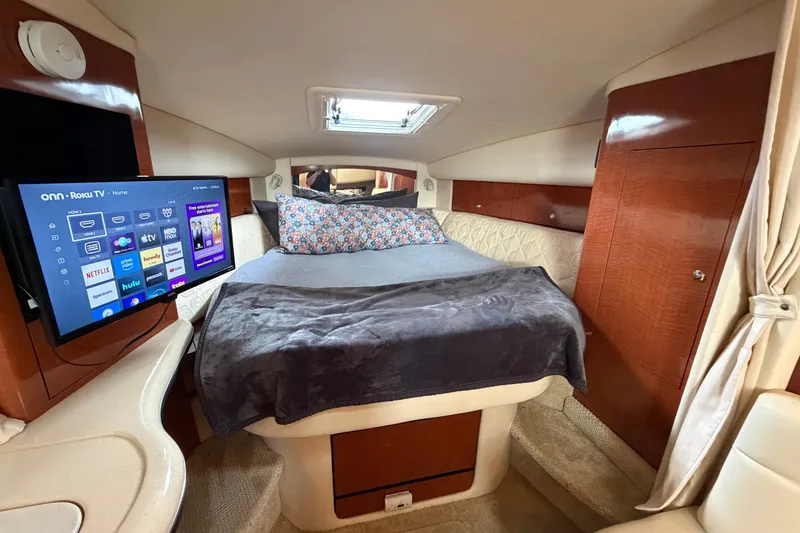 Slide: The Image of Luxurious cabin interior of 2003 Sea Ray Sundancer 320 with bed and mounted TV. - 30