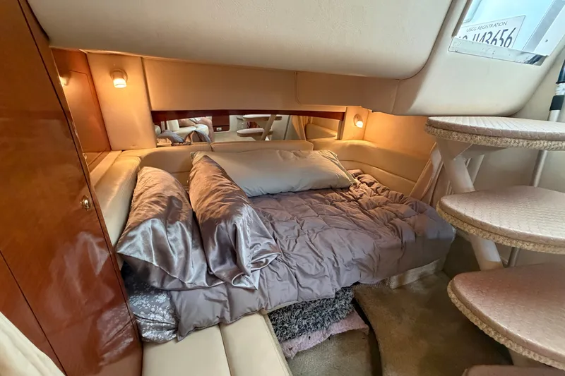 Slide: The Image of Luxurious cabin interior of 2003 Sea Ray Sundancer 320 with cozy bedding and ambient lighting. - 32