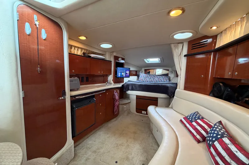 Slide: The Image of Luxurious interior of a 2003 Sea Ray Sundancer 320 yacht with cozy seating and elegant wood finishes. - 36