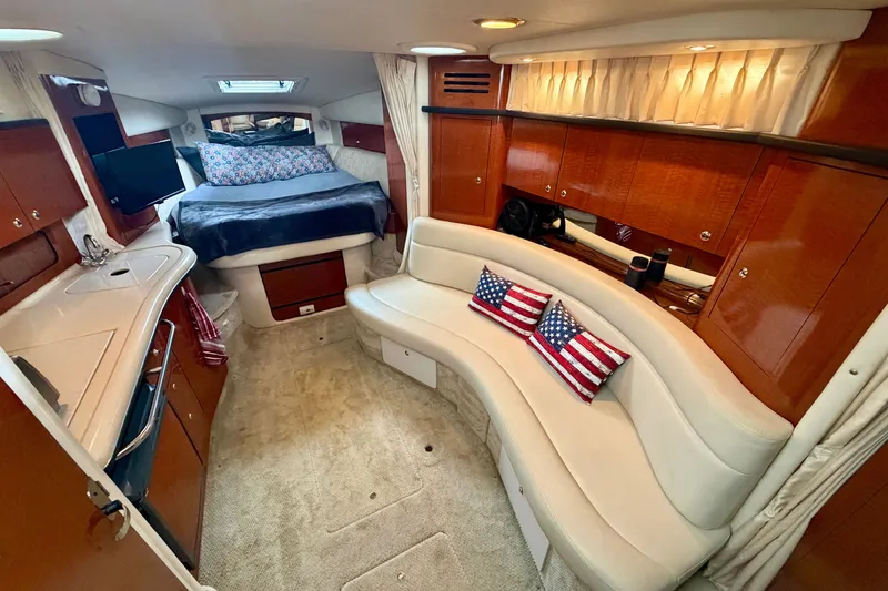 Slide: The Image of Luxurious 2003 Sea Ray Sundancer 320 cabin interior with cozy seating and elegant wood finishes. - 26