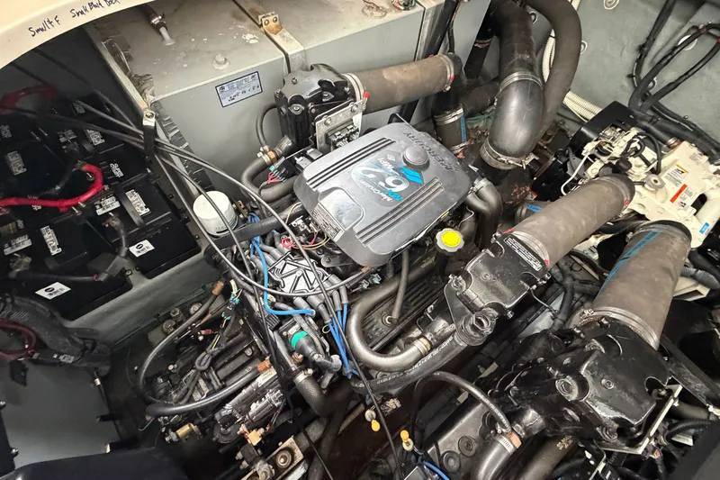 Slide: The Image of Engine compartment of a 2003 Sea Ray Sundancer 320, showcasing mechanical components and wiring. - 38