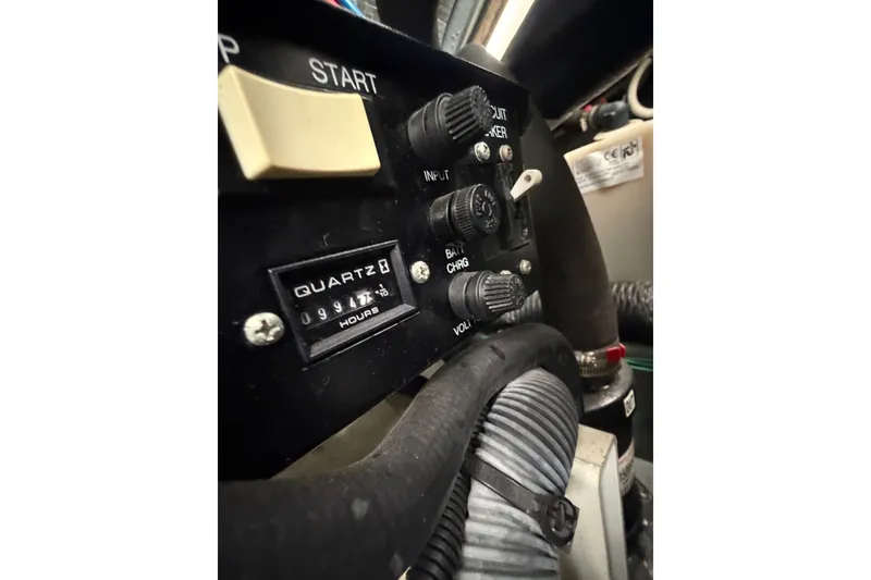 Slide: The Image of Control panel of a 2003 Sea Ray Sundancer 320 boat, featuring switches and hour meter. - 41