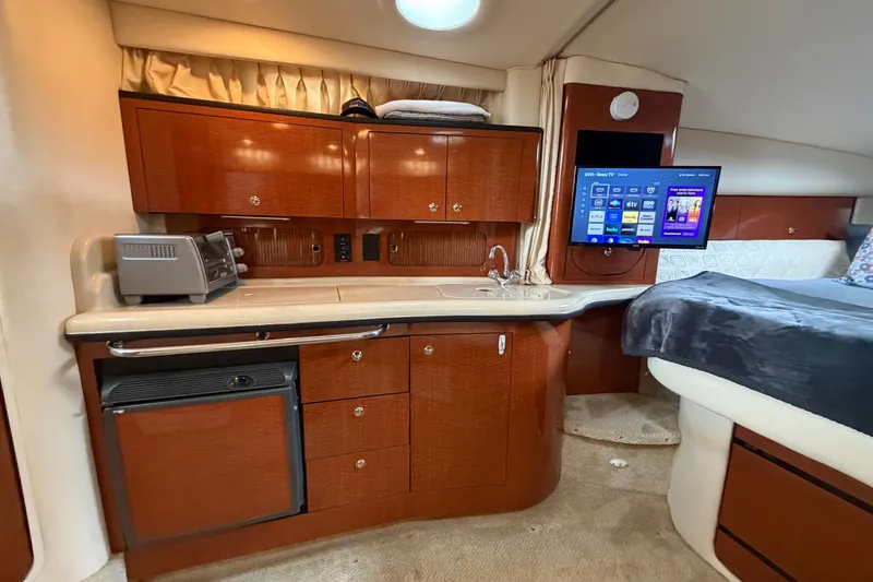 Slide: The Image of Luxurious 2003 Sea Ray Sundancer 320 cabin interior with kitchenette and mounted TV. - 29