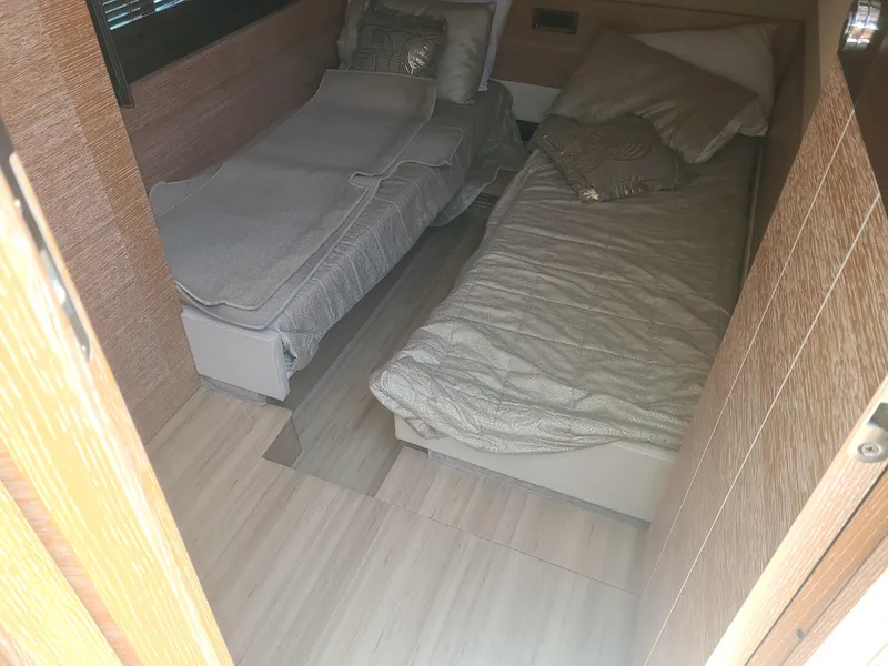 Slide: The Image of Two single beds in a cozy cabin with wooden walls and soft pillows. - 52