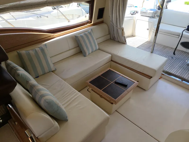 Slide: The Image of Luxurious interior of 2011 Azimut 47 yacht with cream leather seating and striped cushions. - 31