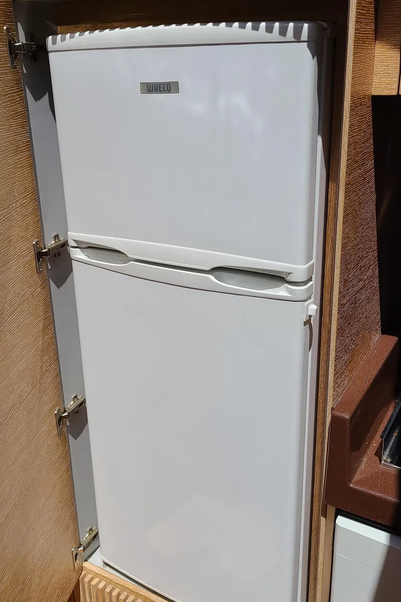 Slide: The Image of White refrigerator in the kitchen of a 2011 Azimut 47 yacht. - 39