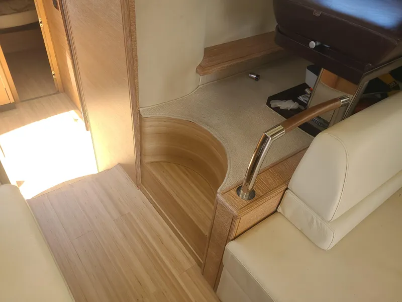 Slide: The Image of Interior of a 2011 Azimut 47 yacht with wooden flooring and beige seating. - 13
