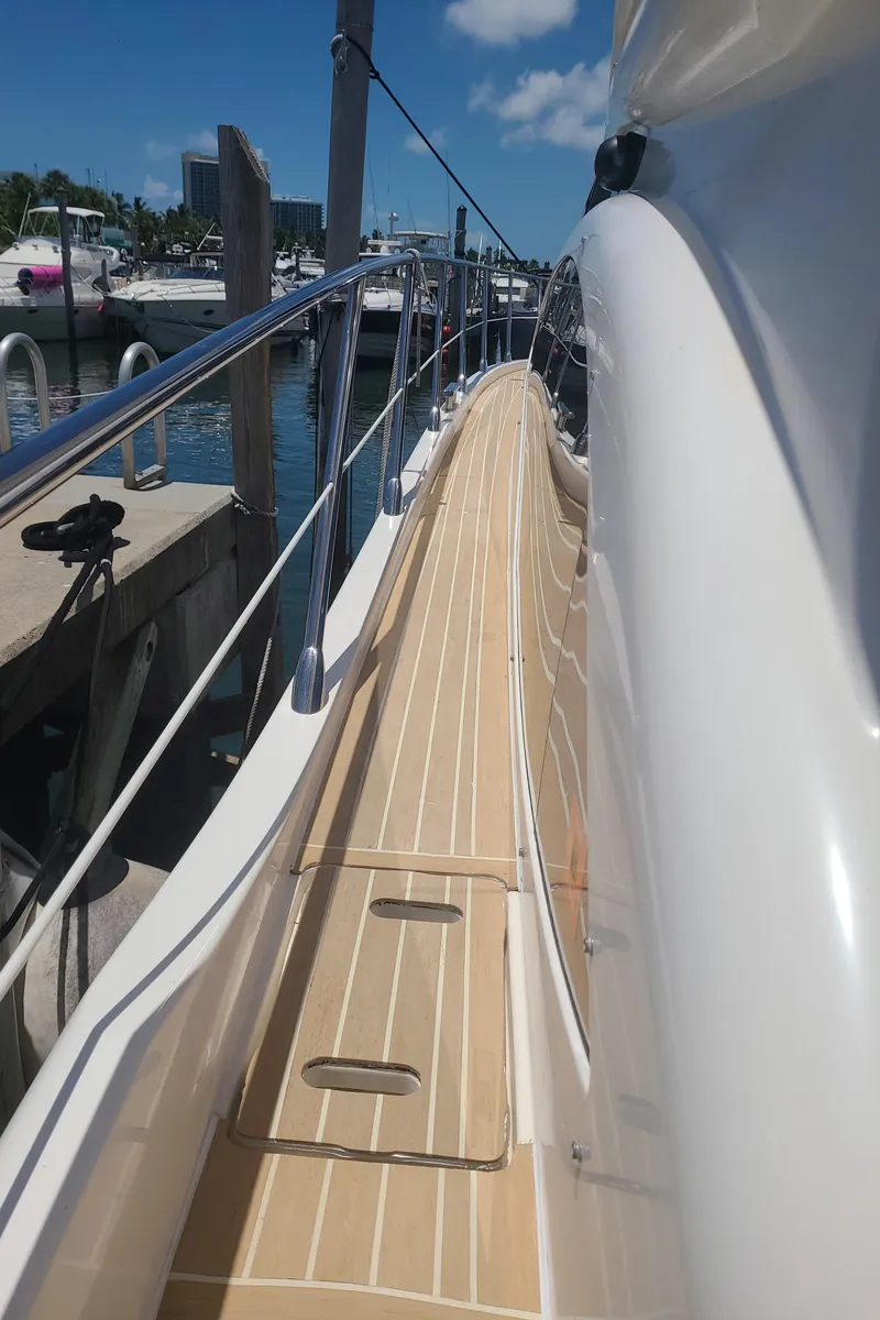 Slide: The Image of Side deck view of a 2011 Azimut 47 yacht docked at a marina. - 5