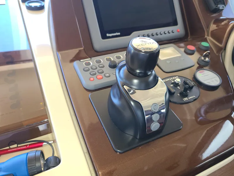 Slide: The Image of Control panel of a 2011 Azimut 47 yacht with joystick and navigation screen. - 16