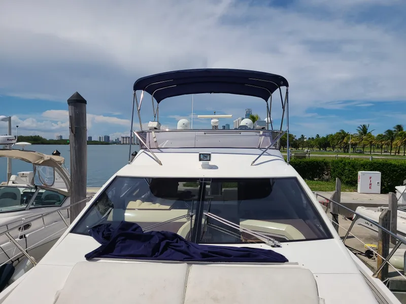 Slide: The Image of 2011 Azimut 47 yacht docked at marina with blue canopy. - 1