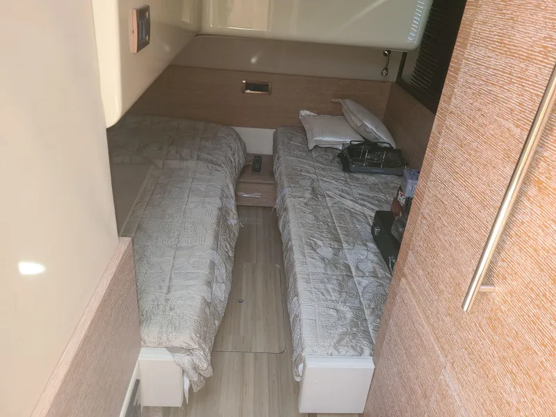 Slide: The Image of The 2011 Azimut 47 cabin features two single beds with neutral bedding. - 50