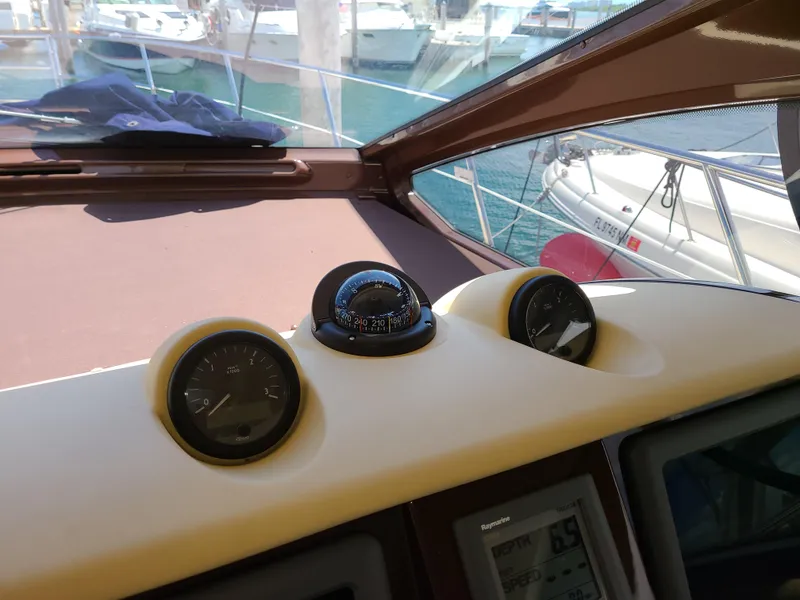 Slide: The Image of Dashboard of a 2011 Azimut 47 yacht with gauges and compass. - 29