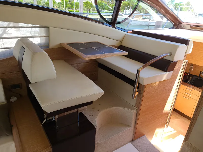 Slide: The Image of Interior seating area of a 2011 Azimut 47 yacht with a wooden table. - 37